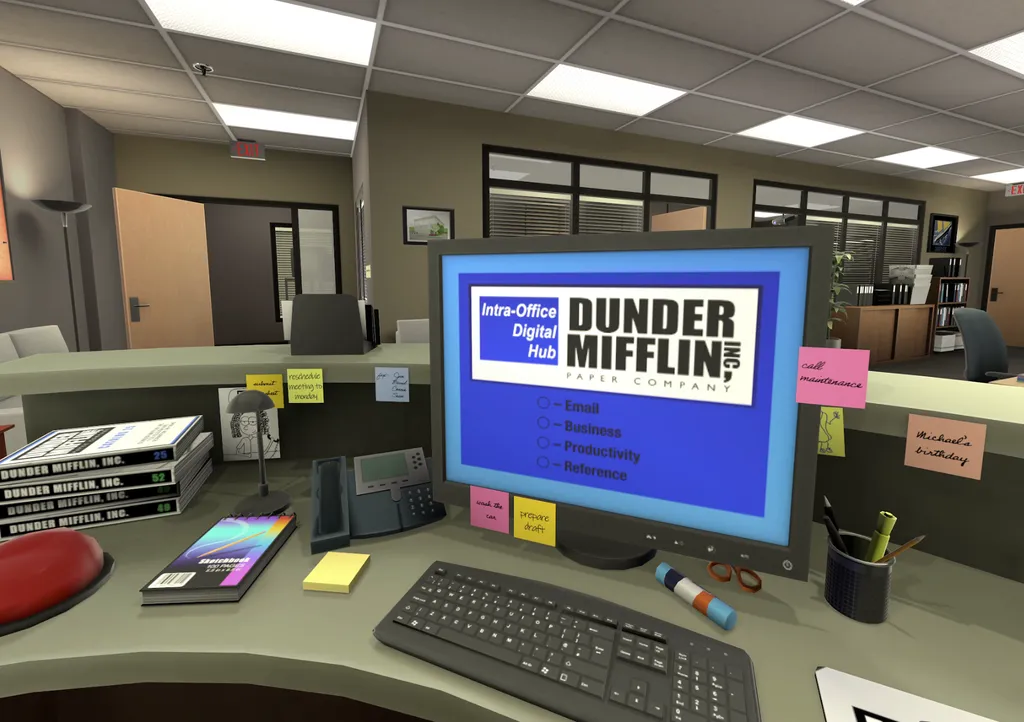 First-person view from a desk at Dunder Mifflin showing a computer and office supplies.